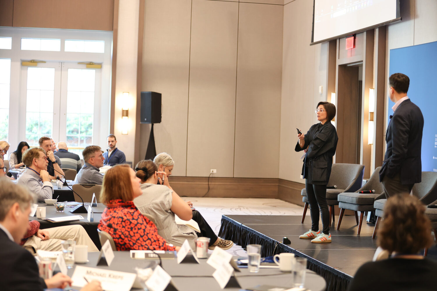 Karen Biddle Andres and Jason Ewas present at a forum.